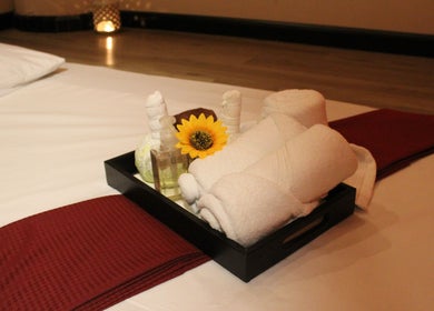 Relaxing spa setup at Feet Lounge Reflexology & Spa - Bay Avenue Mall, دبي, دبي, AE with towels and sunflower.