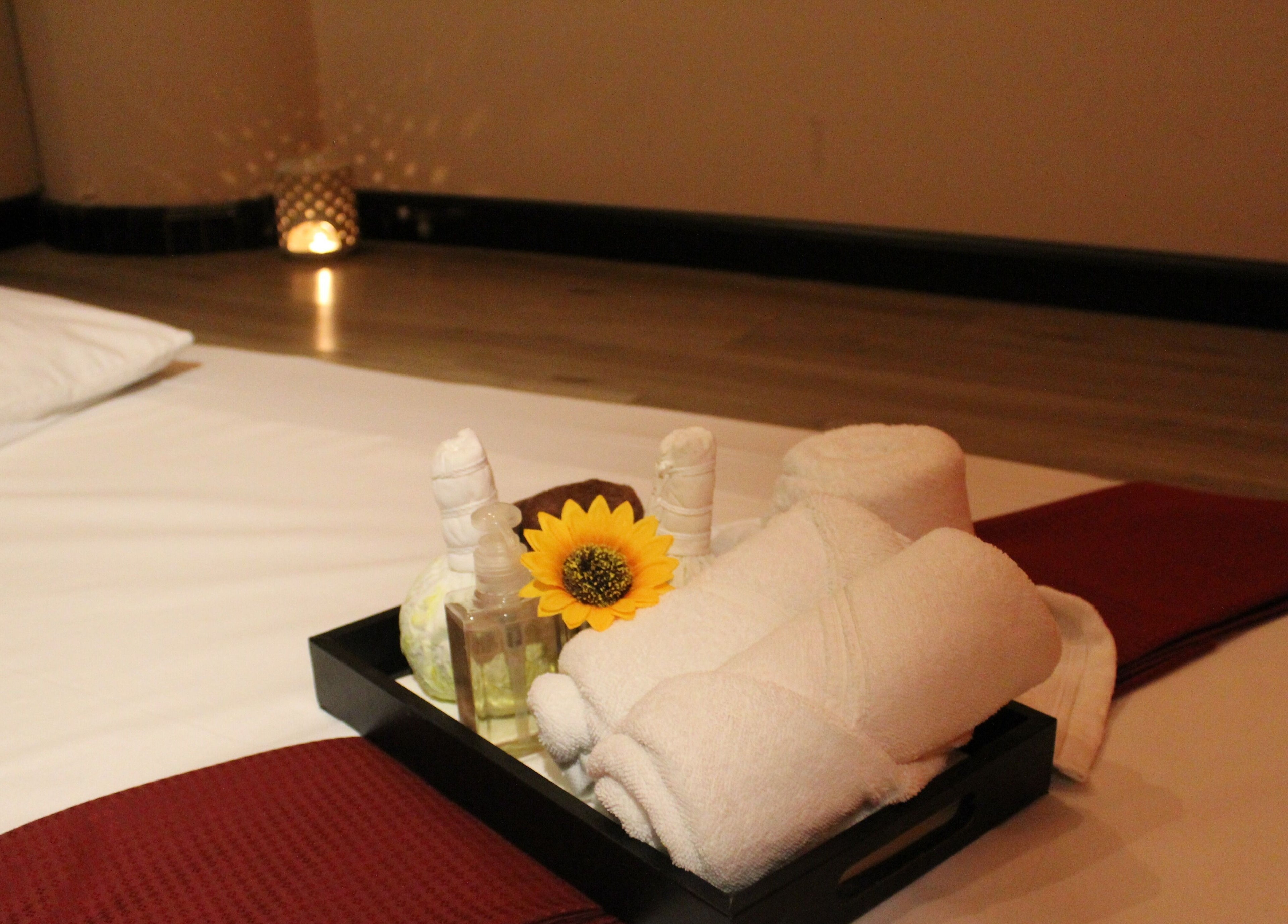 Towel and sunflower setup at Feet Lounge Reflexology & Spa - Bay Avenue Mall, دبي, دبي, AE for relaxation.