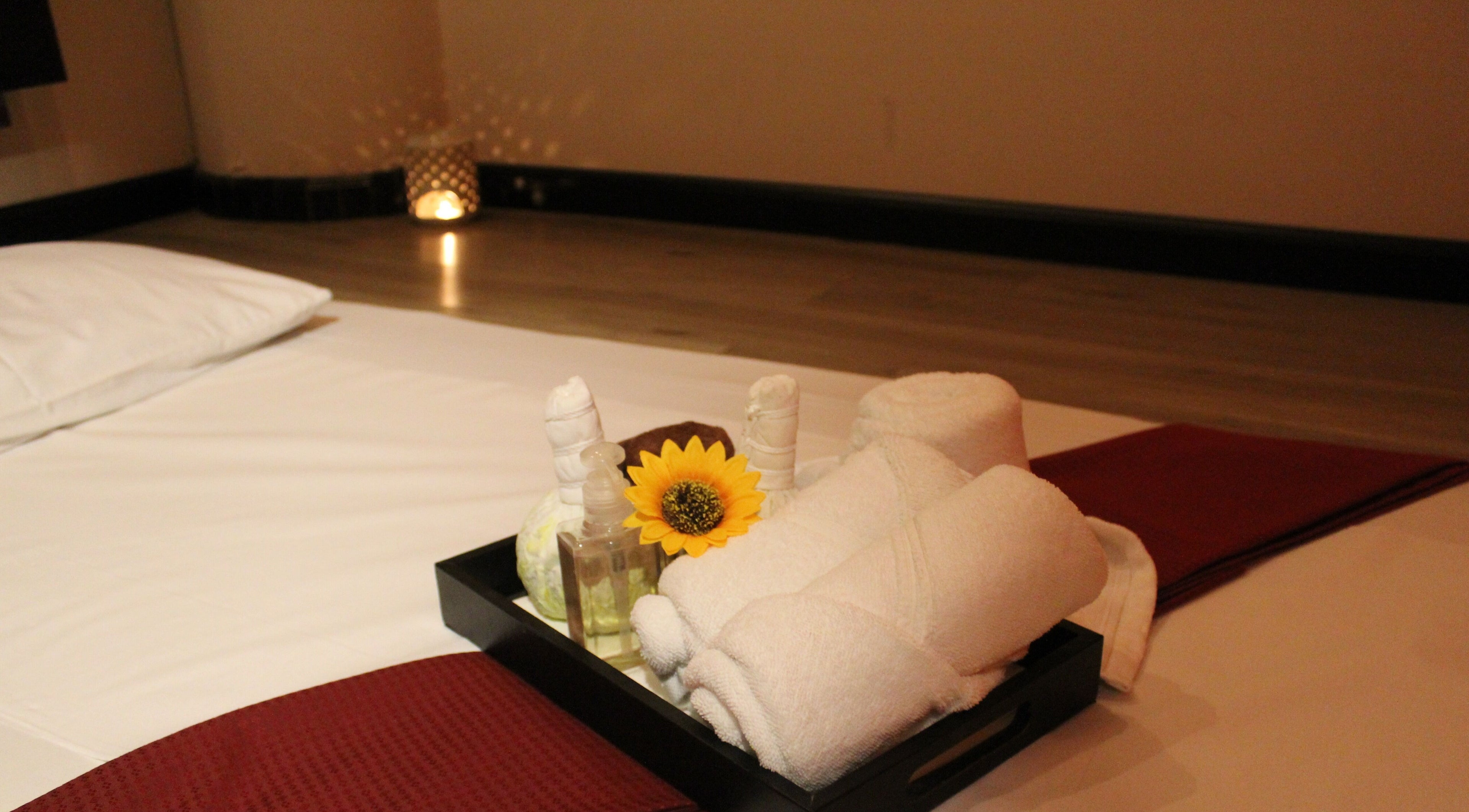 Towel and sunflower setup at Feet Lounge Reflexology & Spa - Bay Avenue Mall, دبي, دبي, AE for relaxation.