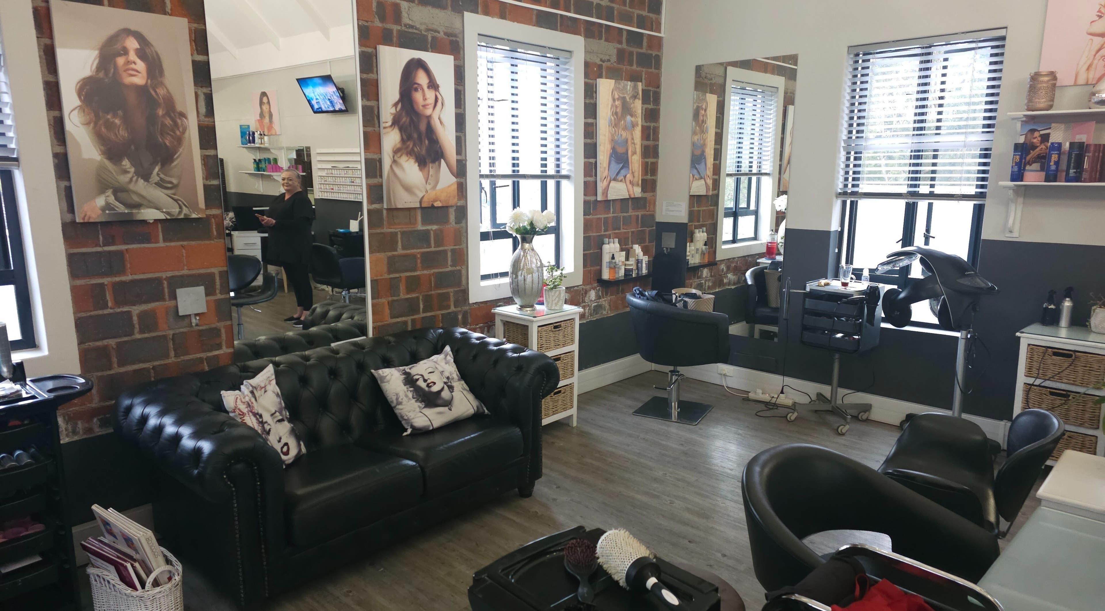 Modern salon interior at Hair Artistry By Alex in Cape Town, Western Cape, ZA. Cozy seating and stylish decor.