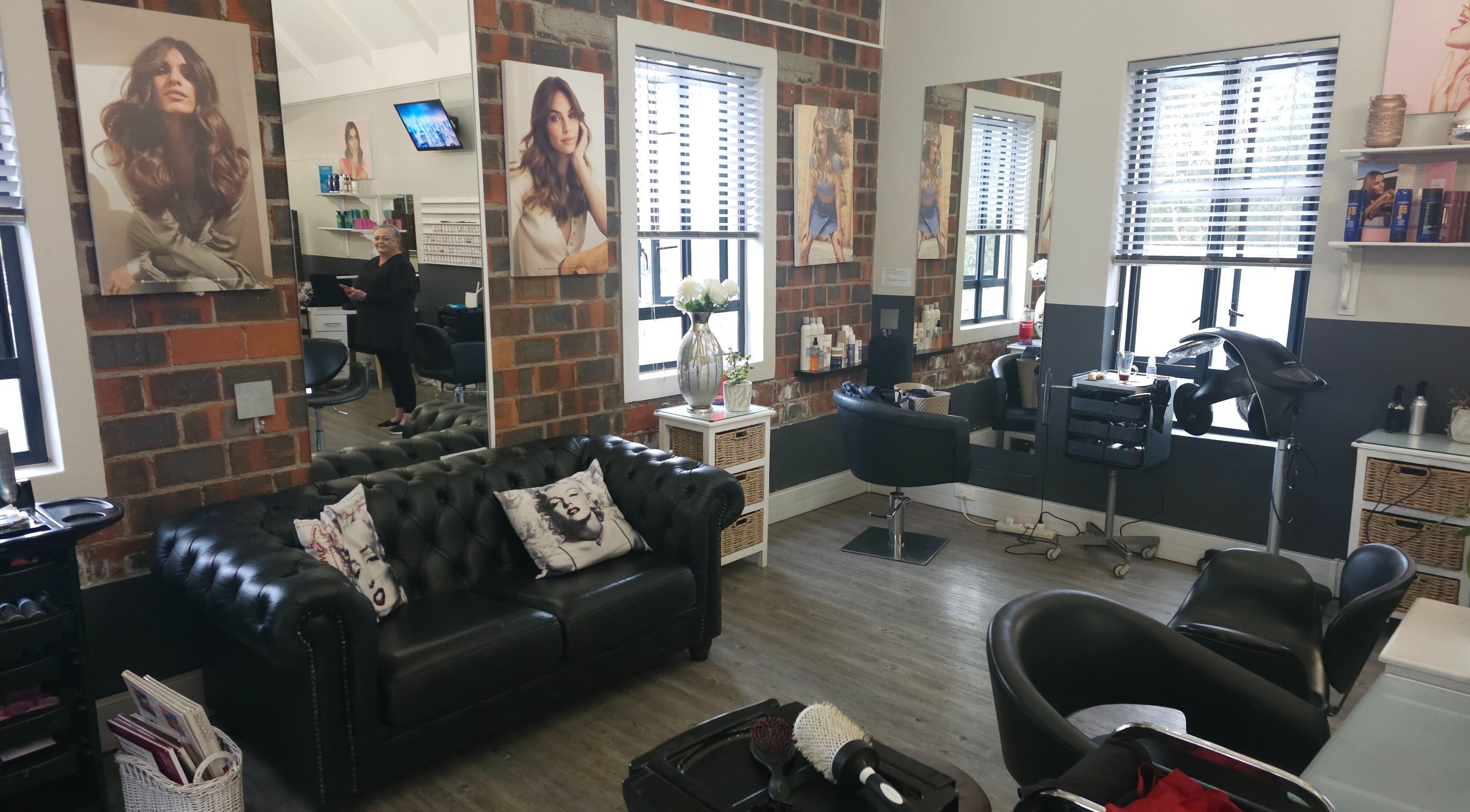 Modern salon interior at Hair Artistry By Alex in Cape Town, Western Cape, ZA. Cozy seating and stylish decor.