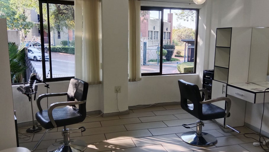 Bright salon interior at Tylaz Hair Studio, Randburg, Gauteng, ZA showcasing stylish chairs and large windows.