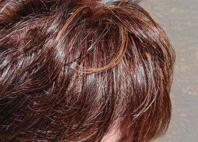 Close-up of vibrant, shiny brown hair styled elegantly at Tylaz Hair Studio in Randburg, Gauteng, ZA.