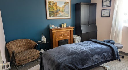 Massage therapy room at Marie Horbas RMT, West Saint Paul, Manitoba, CA, featuring a fireplace and elegant decor.