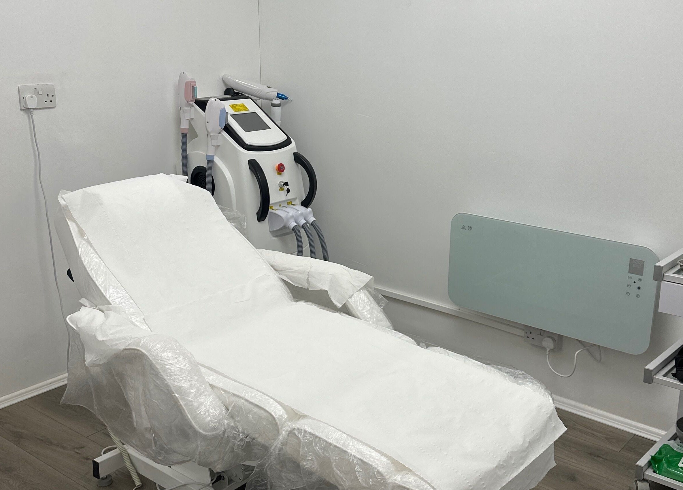 Modern treatment room at Home of Aesthetics and Beauty in Blackwood, Wales, GB, featuring advanced equipment.