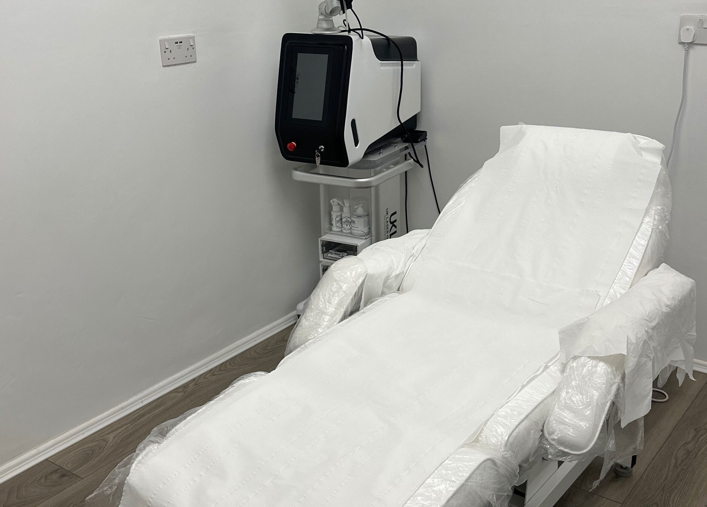 Modern treatment room at Home of Aesthetics and Beauty, Blackwood, Wales, GB, featuring a sleek therapy bed.