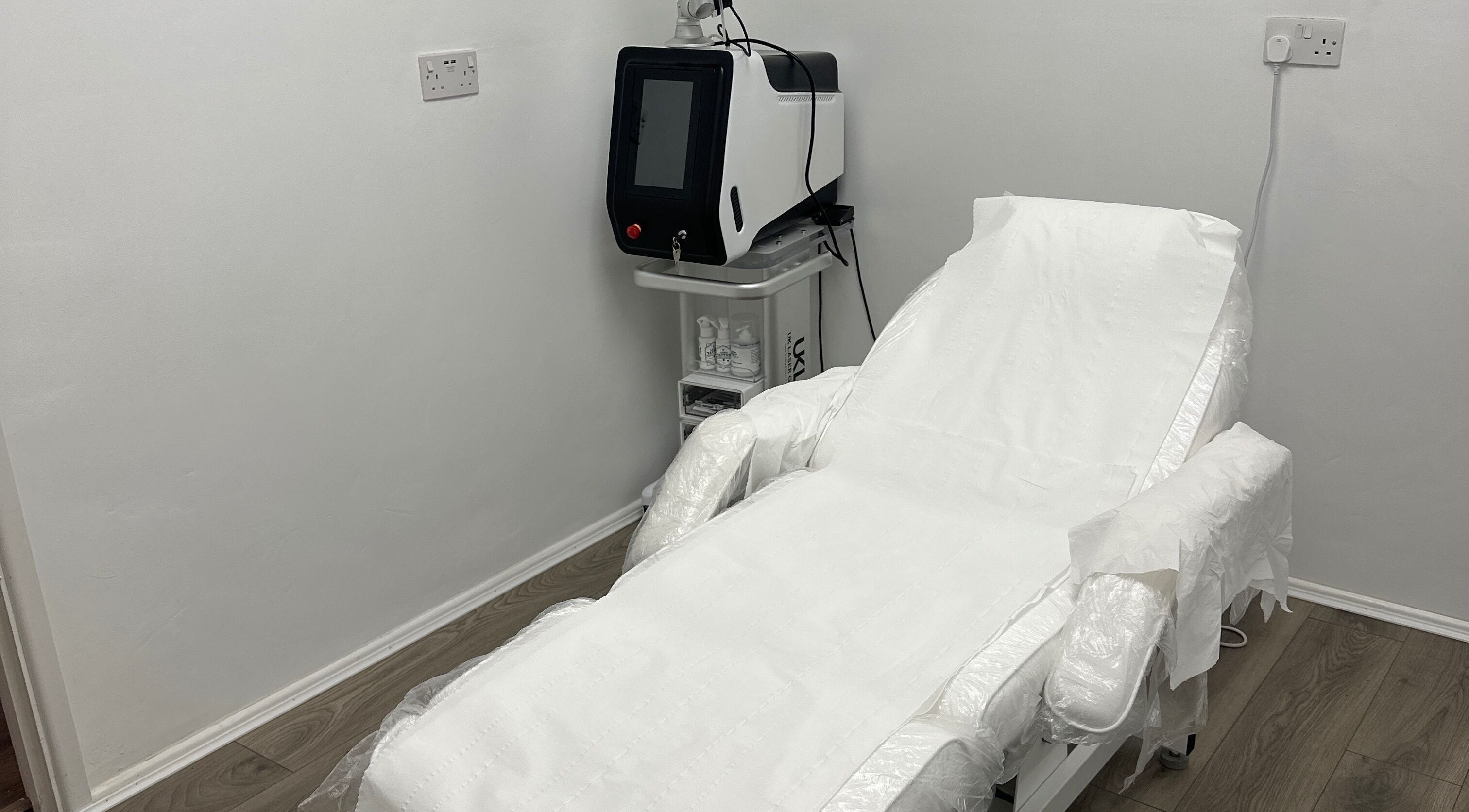 Modern treatment room at Home of Aesthetics and Beauty, Blackwood, Wales, GB, featuring a sleek therapy bed.