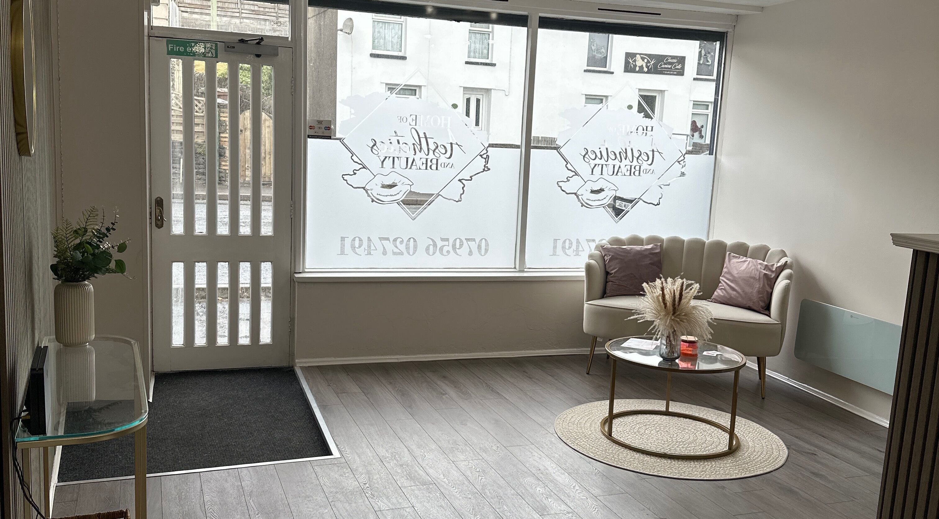 Inviting reception area at Home of Aesthetics and Beauty, Blackwood, Wales, GB with plush seating and decor.