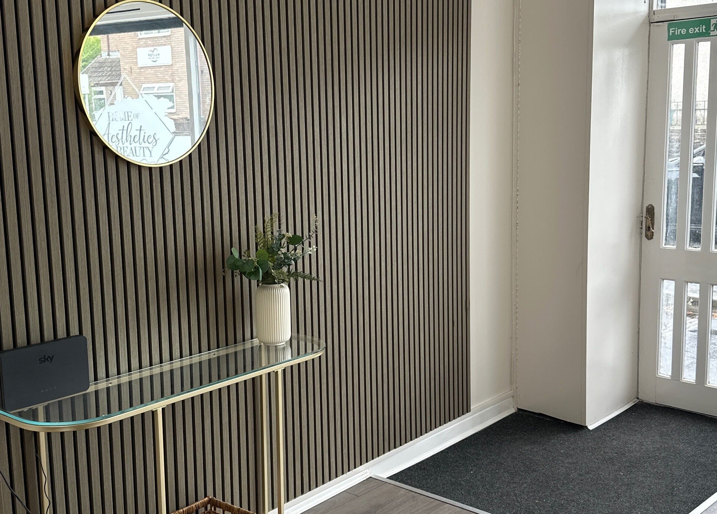 Entrance area of Home of Aesthetics and Beauty in Blackwood, Wales, GB, featuring a stylish mirror and decor.