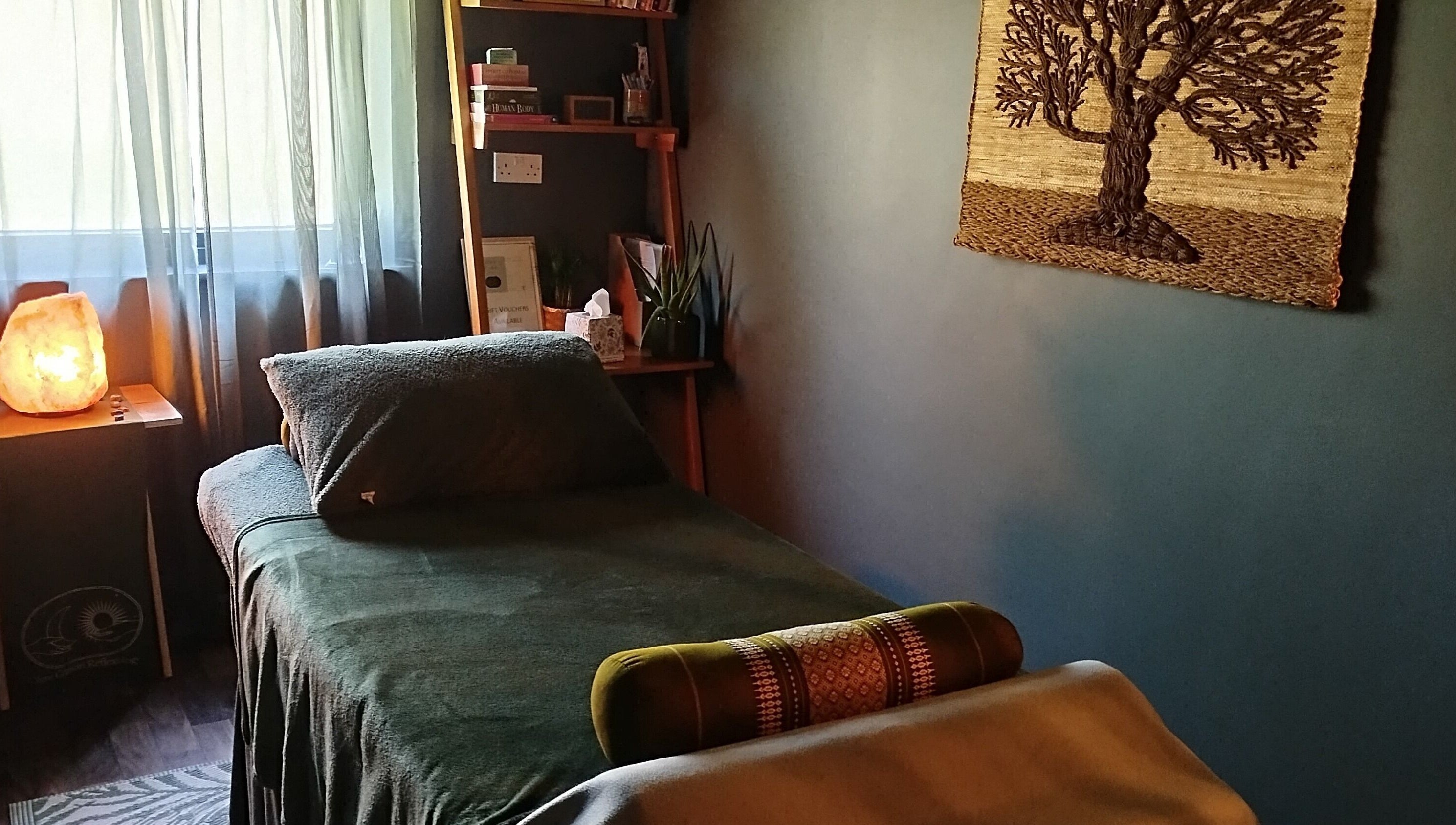 Peaceful therapy room at Clare Carson Reflexology, The Luma Practice, Salford, England, GB with cozy bed and decor.