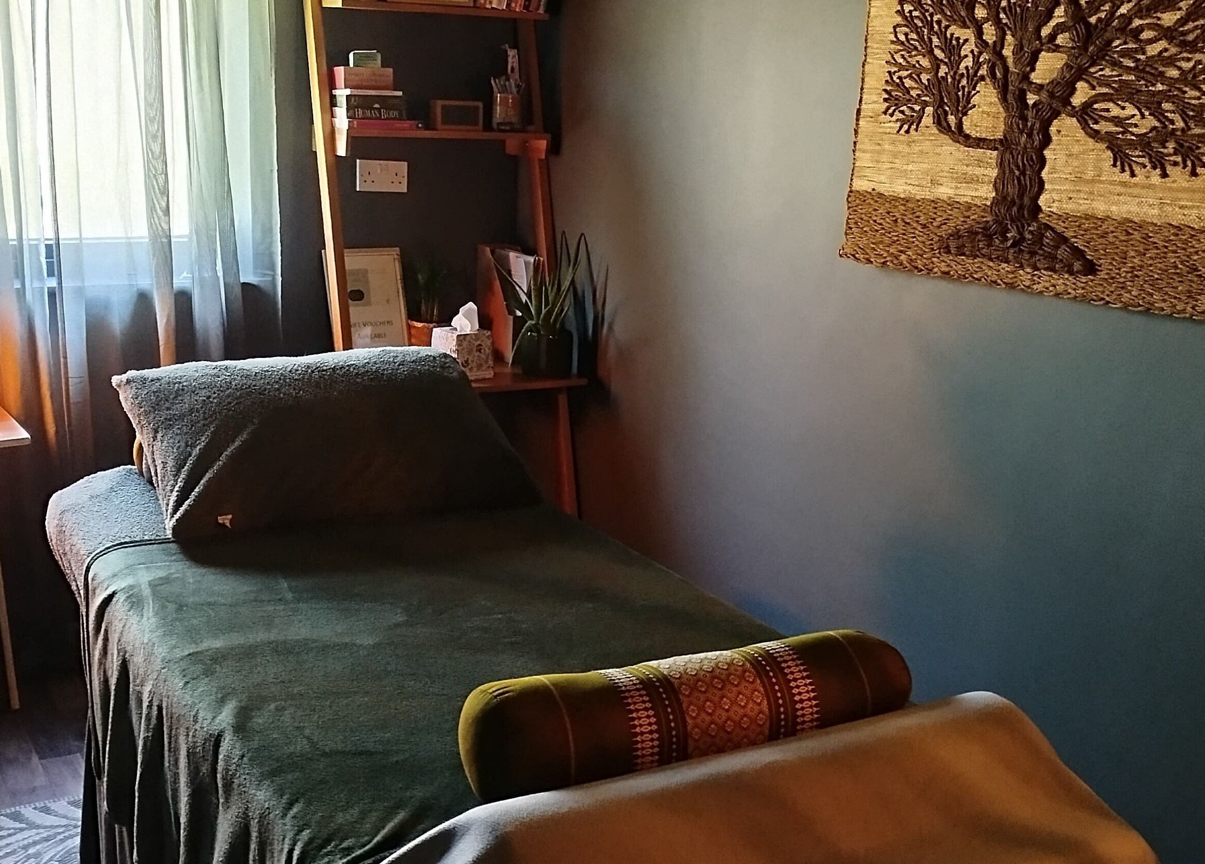 Peaceful therapy room at Clare Carson Reflexology, The Luma Practice, Salford, England, GB with cozy bed and decor.
