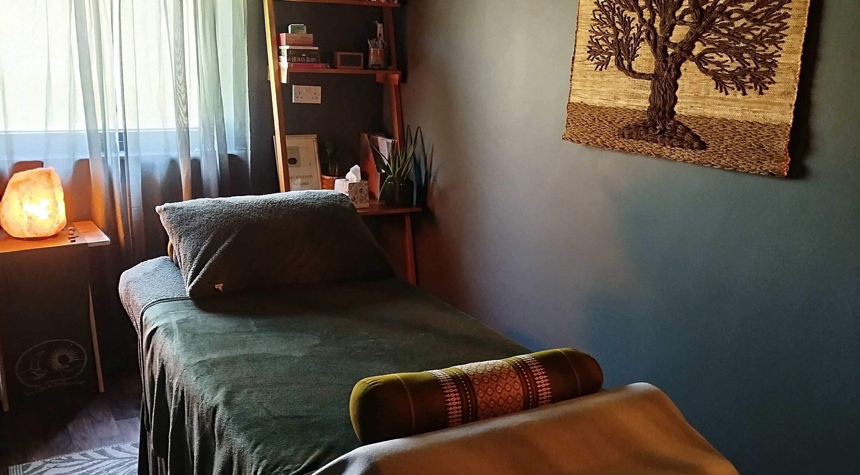 Peaceful therapy room at Clare Carson Reflexology, The Luma Practice, Salford, England, GB with cozy bed and decor.