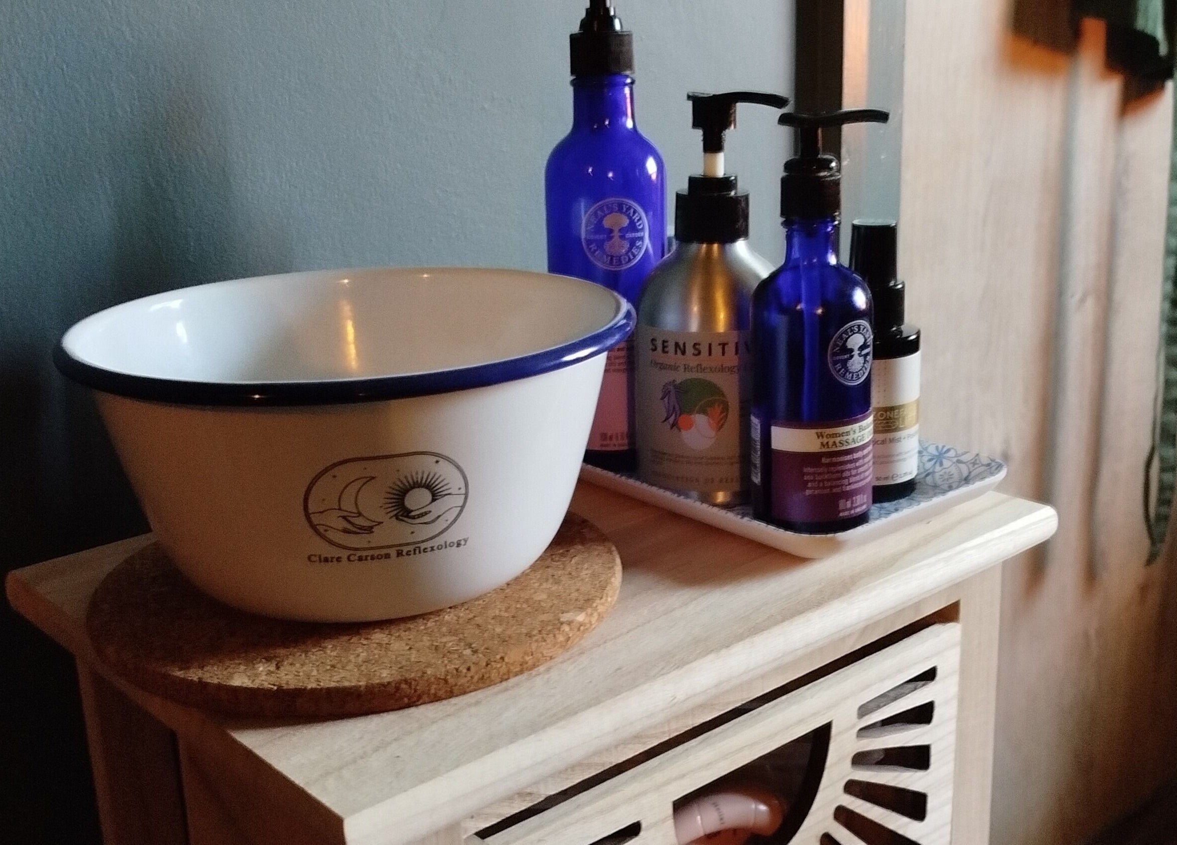 A serene spa setup at Clare Carson Reflexology at The Luma Practice, Salford, England, GB with oils and a bowl.