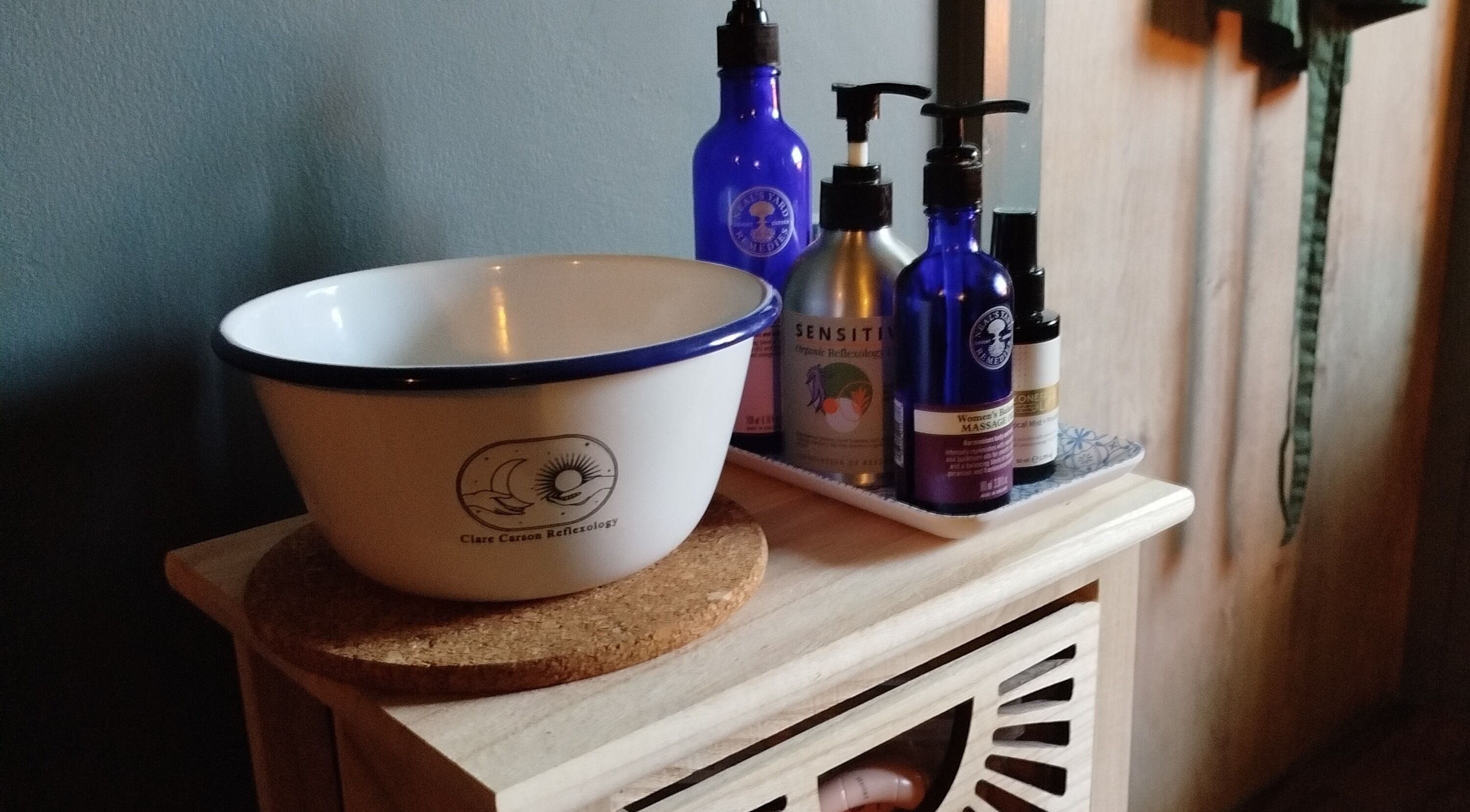 A serene spa setup at Clare Carson Reflexology at The Luma Practice, Salford, England, GB with oils and a bowl.