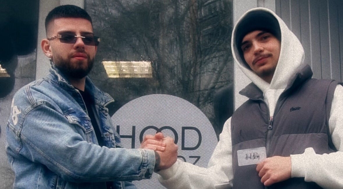 Two people shaking hands in front of Hood Blendz Barbershop, Varna, Varna, BG.