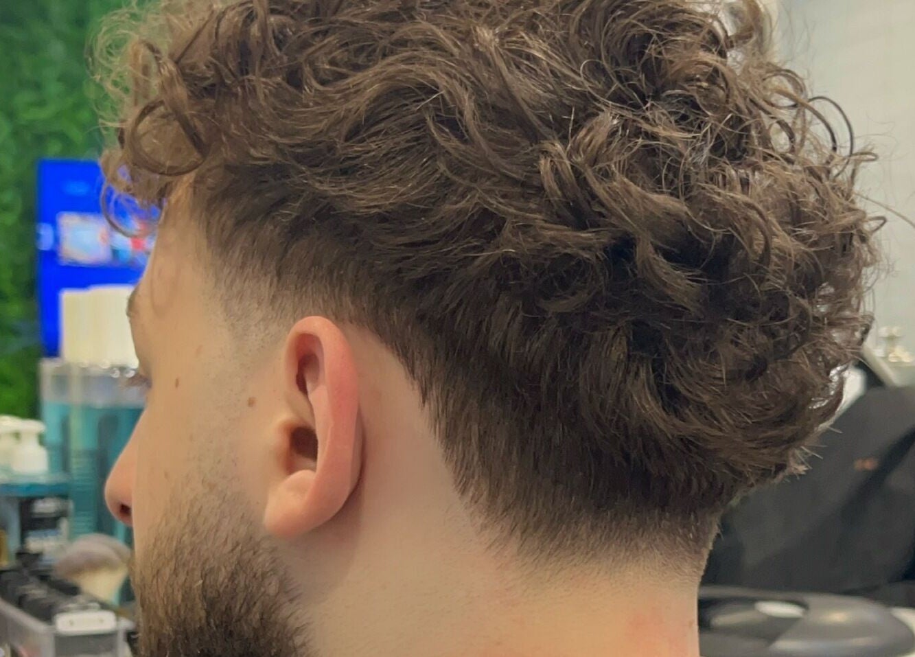 Curly hairstyle with fade at Fade Arcade, Sydenham, New South Wales, AU. Perfect blend for modern looks.