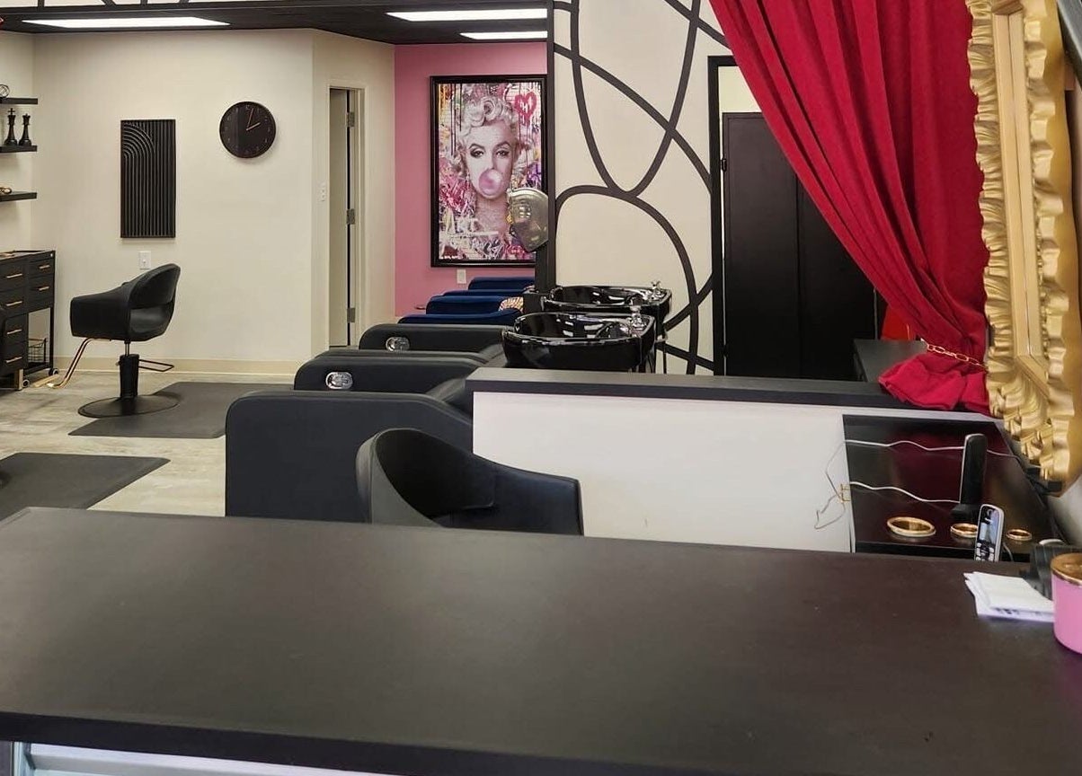 Inside M. Curl at Tangles Salon, Springfield, Missouri, US, featuring chic styling chairs and vibrant decor.