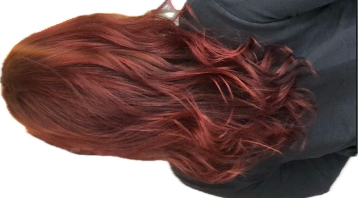 Rich red curls styled at M. Curl at Tangles Salon, Springfield, Missouri, US showcasing vibrant color.