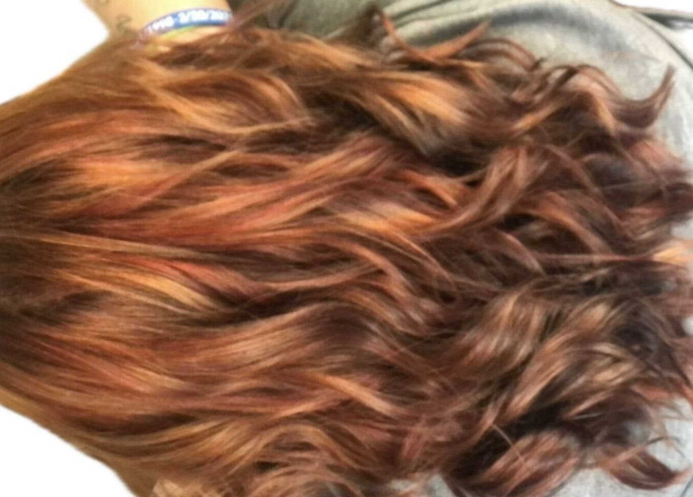 Vibrant copper hair waves styled at M. Curl at Tangles Salon in Springfield, Missouri, US.