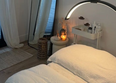 Soothing spa bed with candlelight at THE SKIN PROJECT, Warrington, England, GB. Relaxing ambiance for wellness.