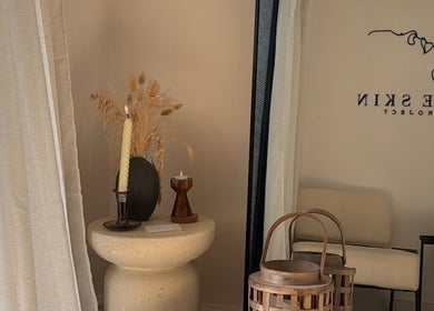 Elegant corner at THE SKIN PROJECT, Warrington, England, GB with rustic decor and a cozy chair.