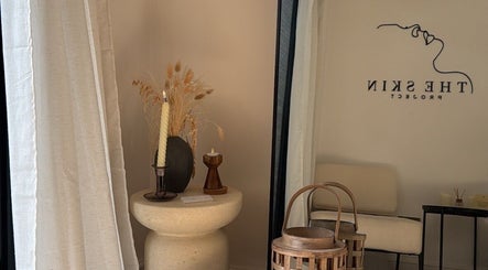 Elegant corner at THE SKIN PROJECT, Warrington, England, GB with rustic decor and a cozy chair.