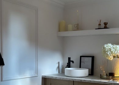 Elegant bathroom at THE SKIN PROJECT, Warrington, England, GB, featuring a modern sink and decorative flowers.