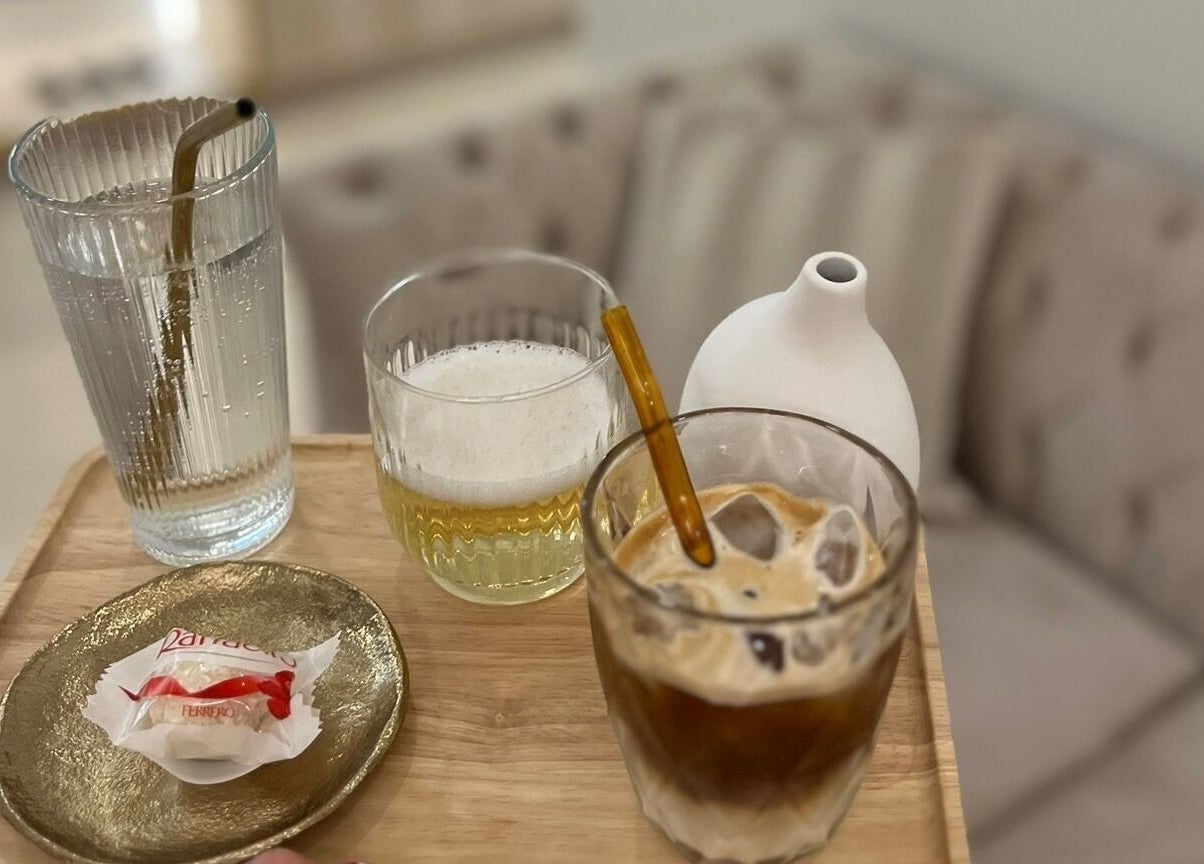 Občerstvení ve WellBe, Hlavní Město Praha, CZ: sklenice na dřevěném tácu v elegantním interiéru.