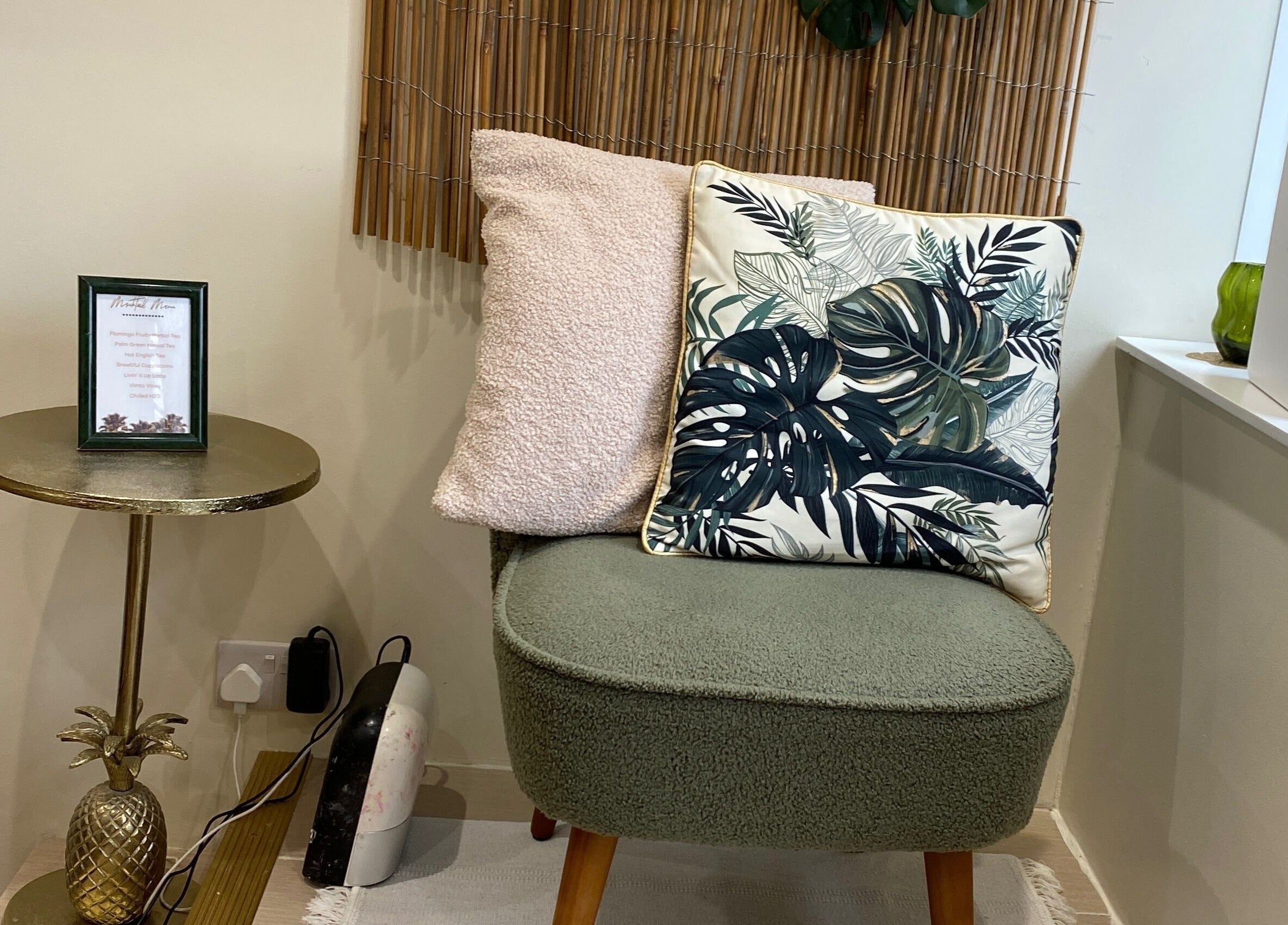 Cozy seating at Flamingo Nails, Park Gate, England, featuring tropical cushions and a chic gold table.