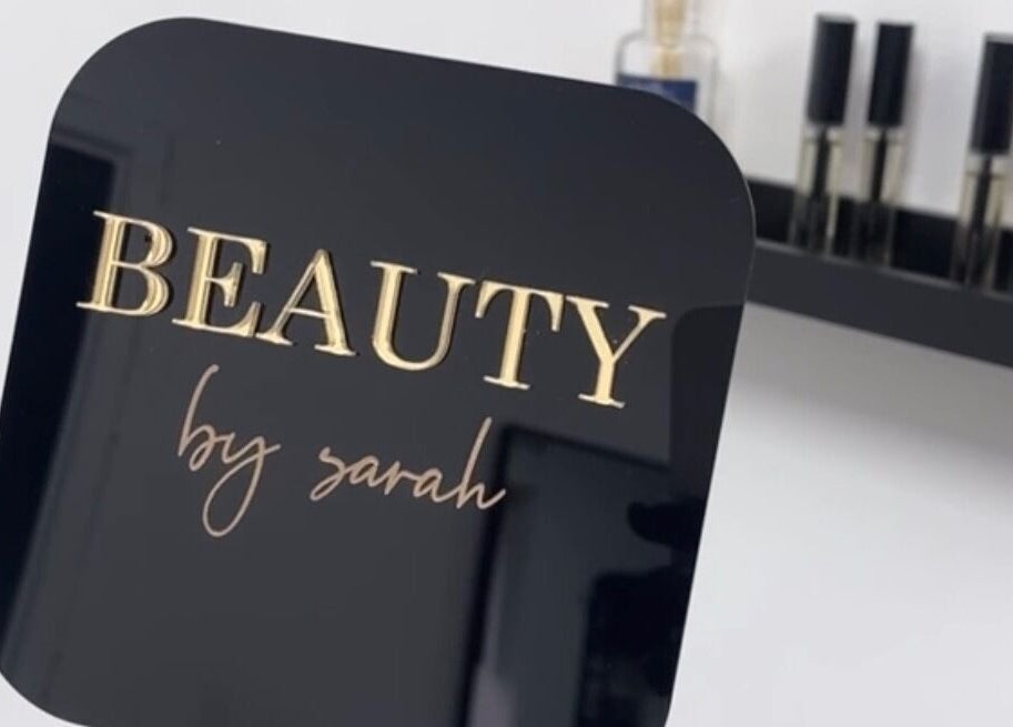 Elegant Beautybysarah sign in Coity, Wales, GB, with sleek beauty products in the background.
