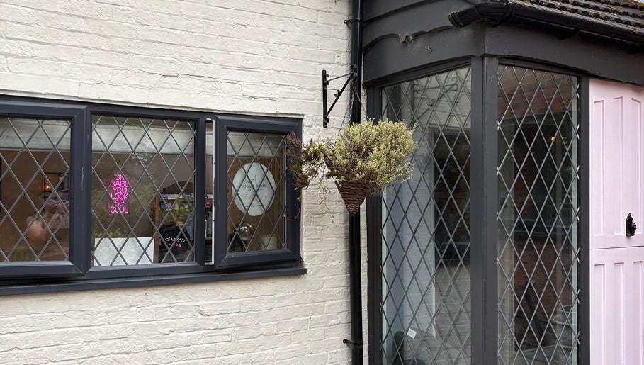 The Vine Hair by Georgia's inviting exterior in Solihull, England, GB showcases a welcoming entrance with flowers.