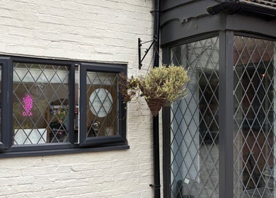 The Vine Hair by Georgia's inviting exterior in Solihull, England, GB showcases a welcoming entrance with flowers.