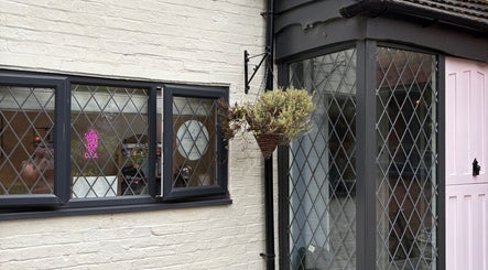 The Vine Hair by Georgia's inviting exterior in Solihull, England, GB showcases a welcoming entrance with flowers.