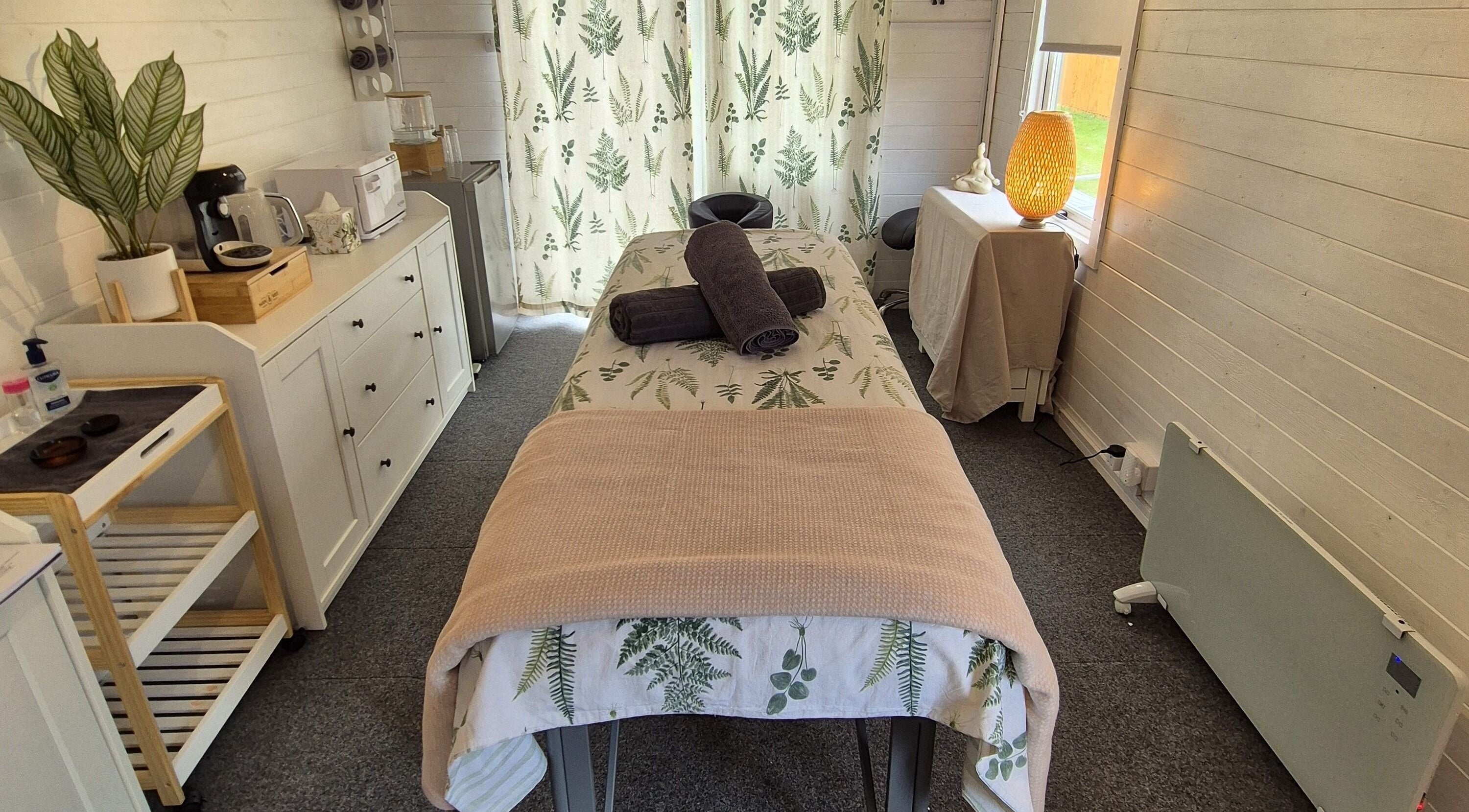 Cozy massage room at Calathea Holistic Health and Wellness, Wimborne, England, GB with warm decor and relaxing ambiance.