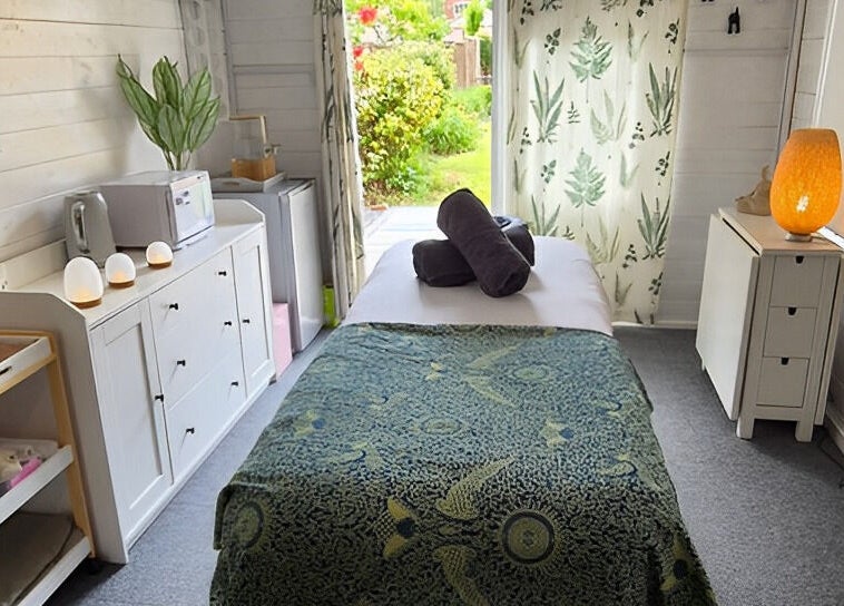 Relaxing massage room at Calathea Holistic Health and Wellness, Wimborne, England, GB, featuring serene decor.