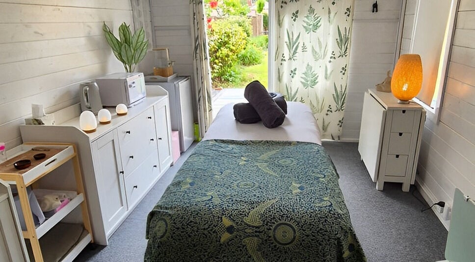 Relaxing massage room at Calathea Holistic Health and Wellness, Wimborne, England, GB, featuring serene decor.