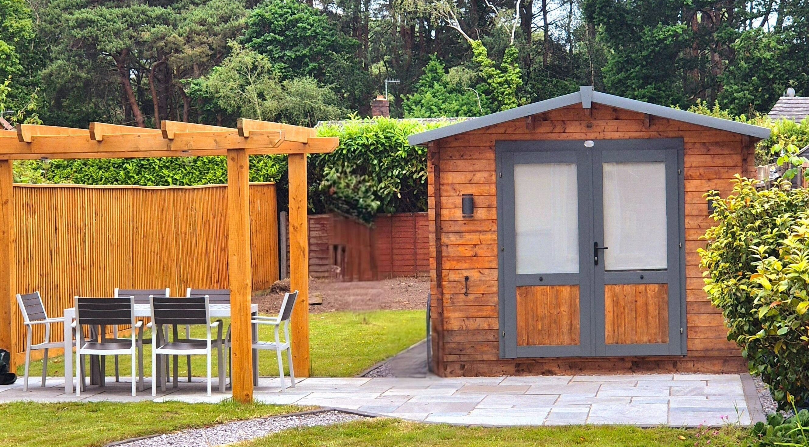 Charming wooden cabin at Calathea Holistic Health and Wellness, Wimborne, England, GB, amidst lush greenery.