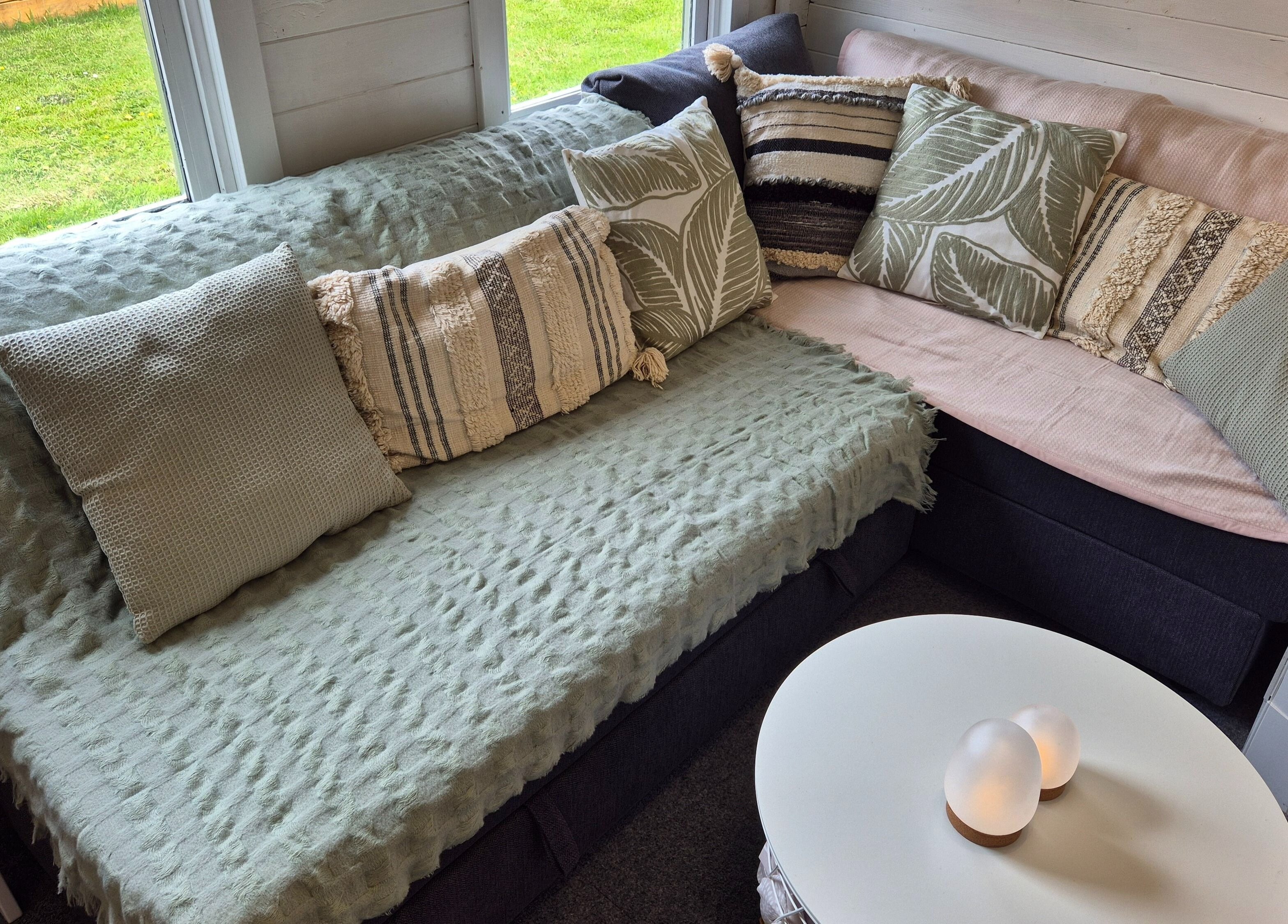 Inviting lounge area with soft cushions at Calathea Holistic Health and Wellness, Wimborne, England, GB.