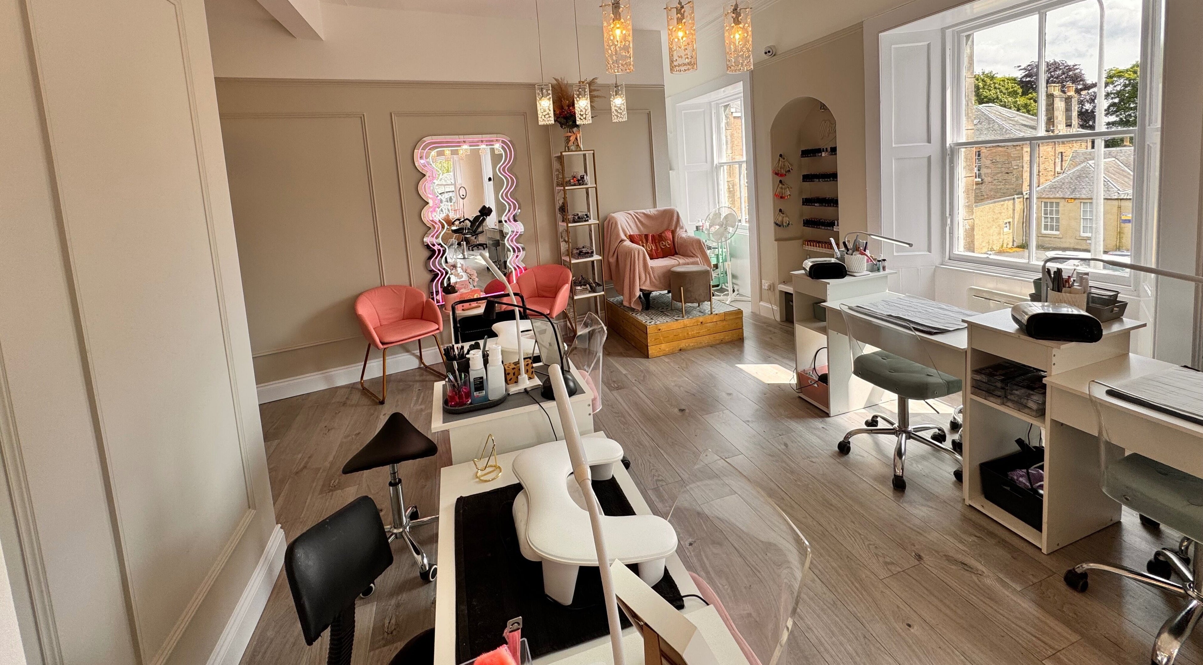 Spacious interior of Queens Beauty and Nails, Dunfermline, Scotland, GB featuring modern nail stations.