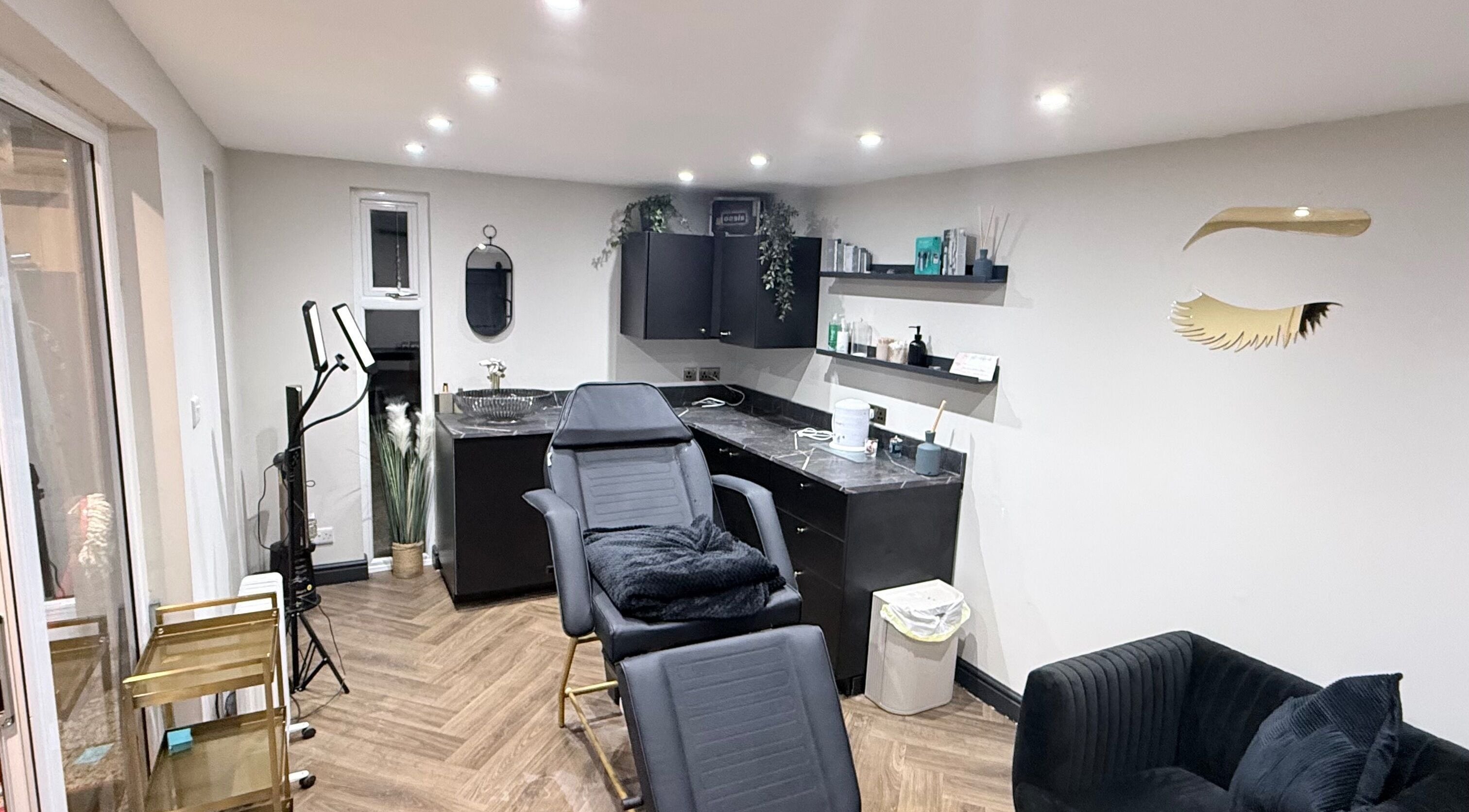 Cozy interior of Lashley Beauty by Ashley, LEVEN, Scotland, GB, featuring a modern treatment chair and elegant decor.