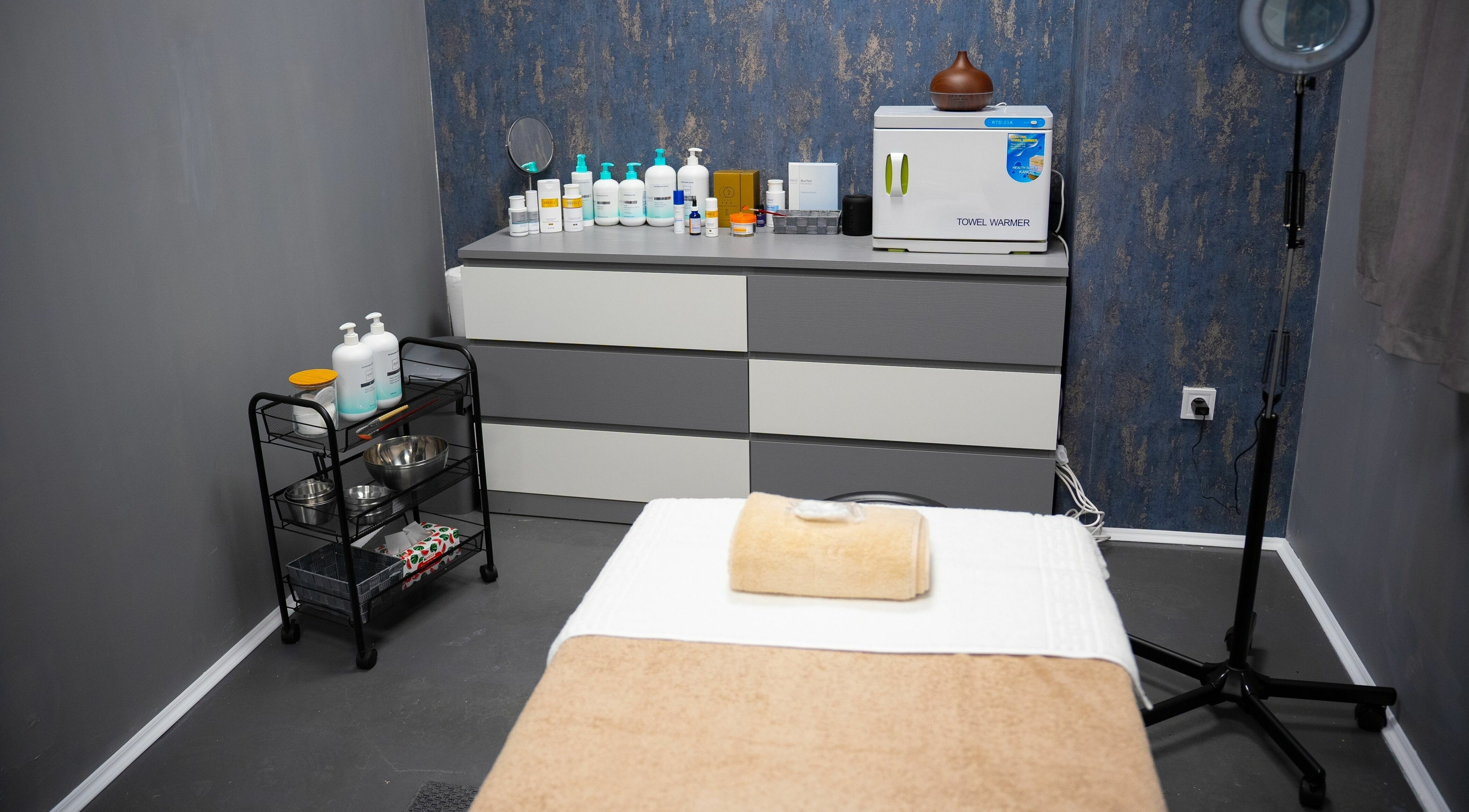 Camera de tratament spa la TheSpa, București, București, RO, cu masă de masaj și produse de îngrijire.