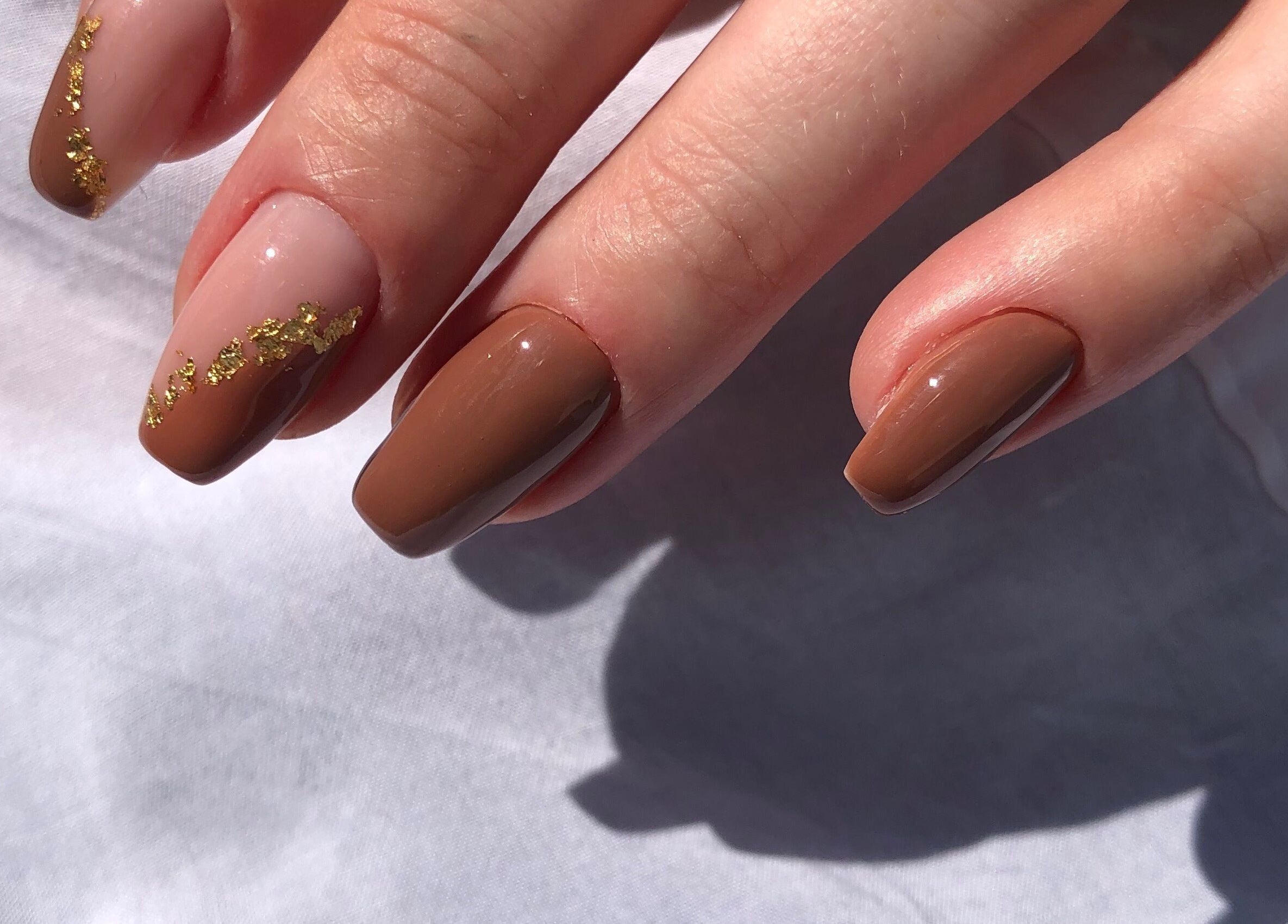 Elegant brown nails with gold leaf accents at Shine On Nails (Salon and Nail Academy), Pretoria, Gauteng, ZA.