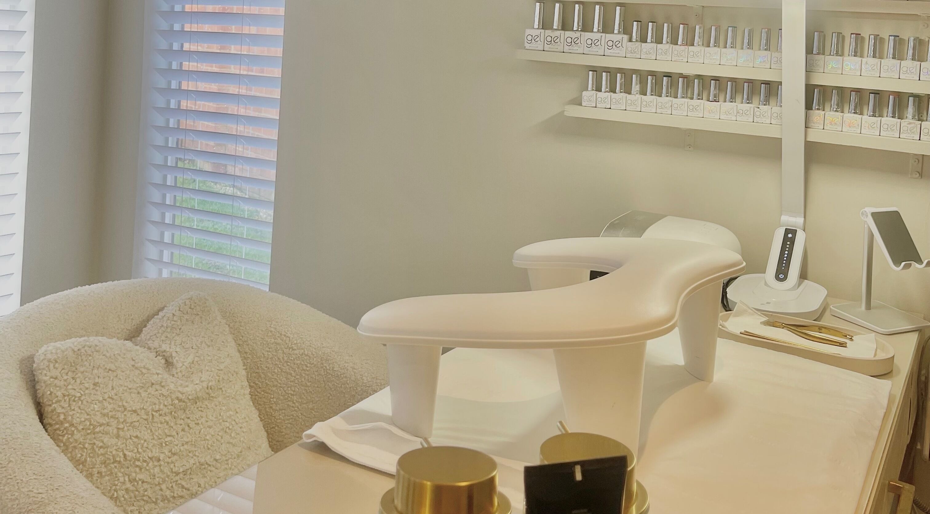 Relaxing nail station at The Nail Girl, Eccles, England, GB with cozy chair and gel polishes.