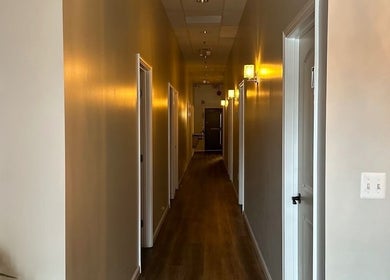 Warm-lit hallway at Gunston Massage in Lorton, Virginia, US, featuring calming ambiance and elegant decor.