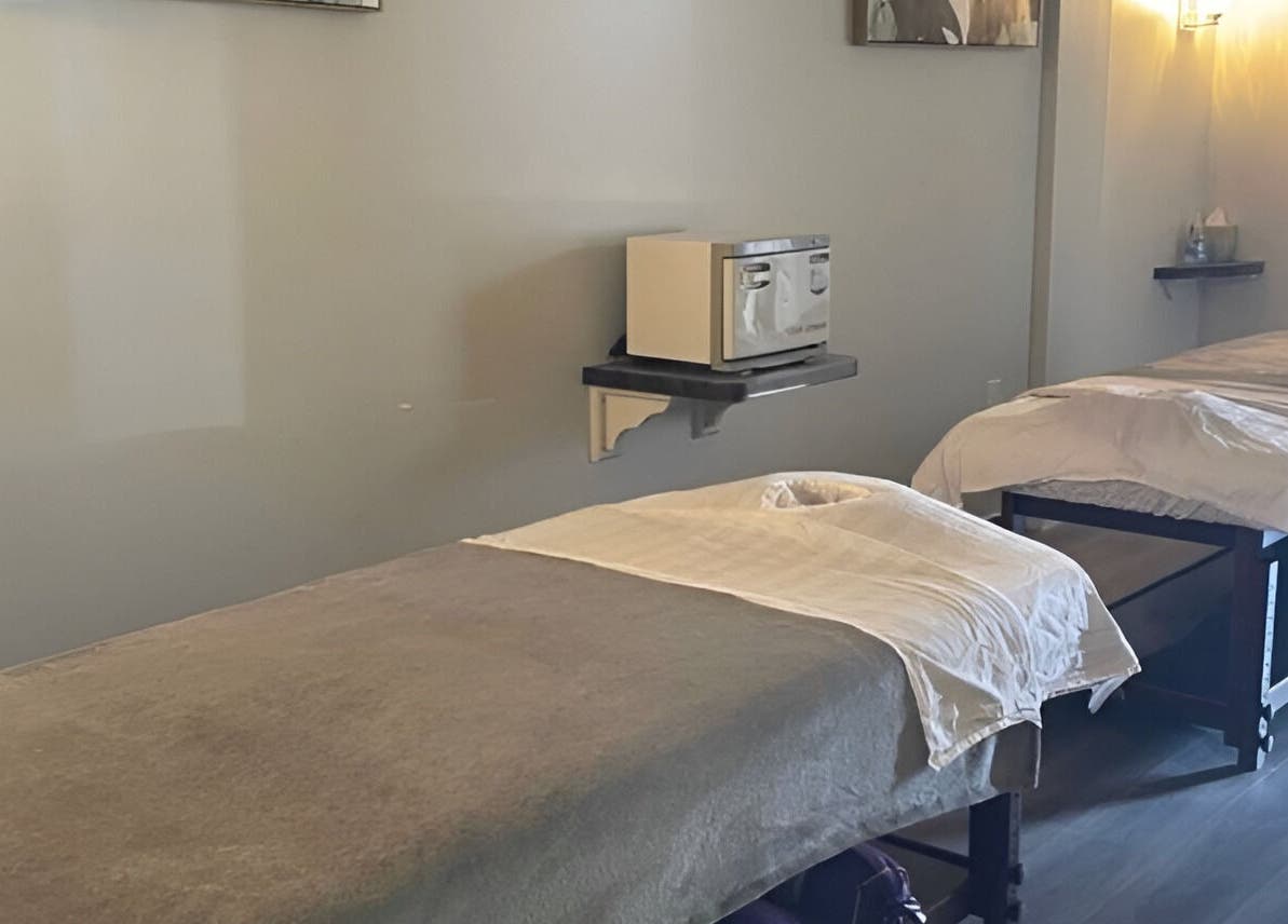 Tranquil massage room at Gunston Massage, Lorton, Virginia, US with two beds and calming lighting.