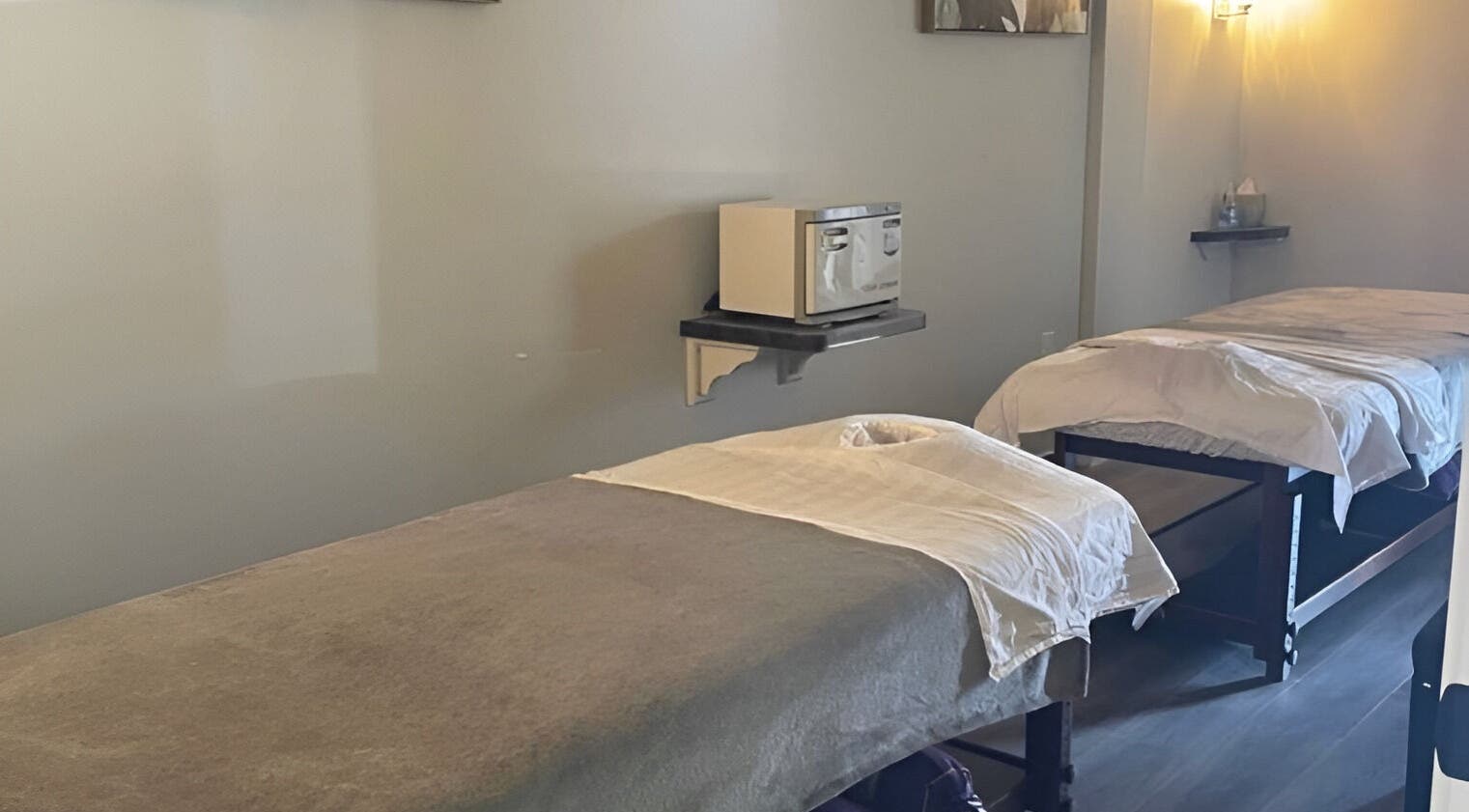 Tranquil massage room at Gunston Massage, Lorton, Virginia, US with two beds and calming lighting.