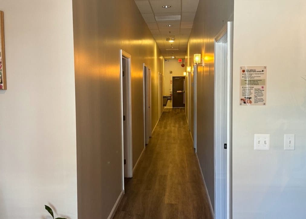Calm hallway at Gunston Massage in Lorton, Virginia, US with ambient lighting and floral decor.