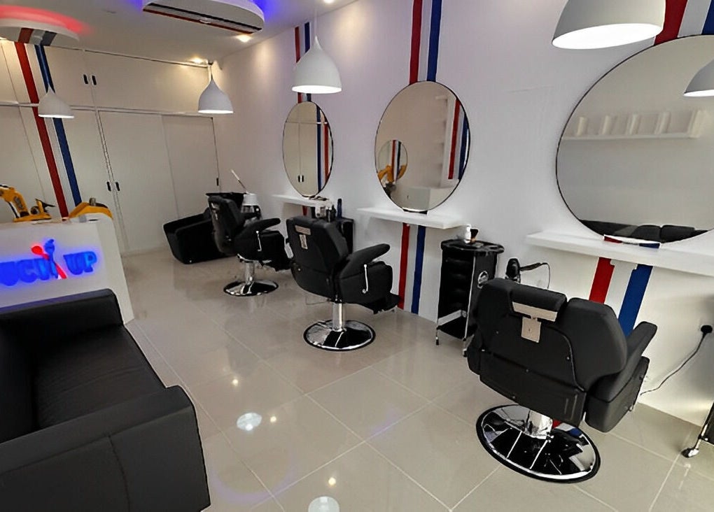 Modern salon interior at TOUCH UP - Wadi Kabir, Muscat, Oman. Sleek black chairs and mirrors, Wadi Al Kabir, Muscat Governorate.