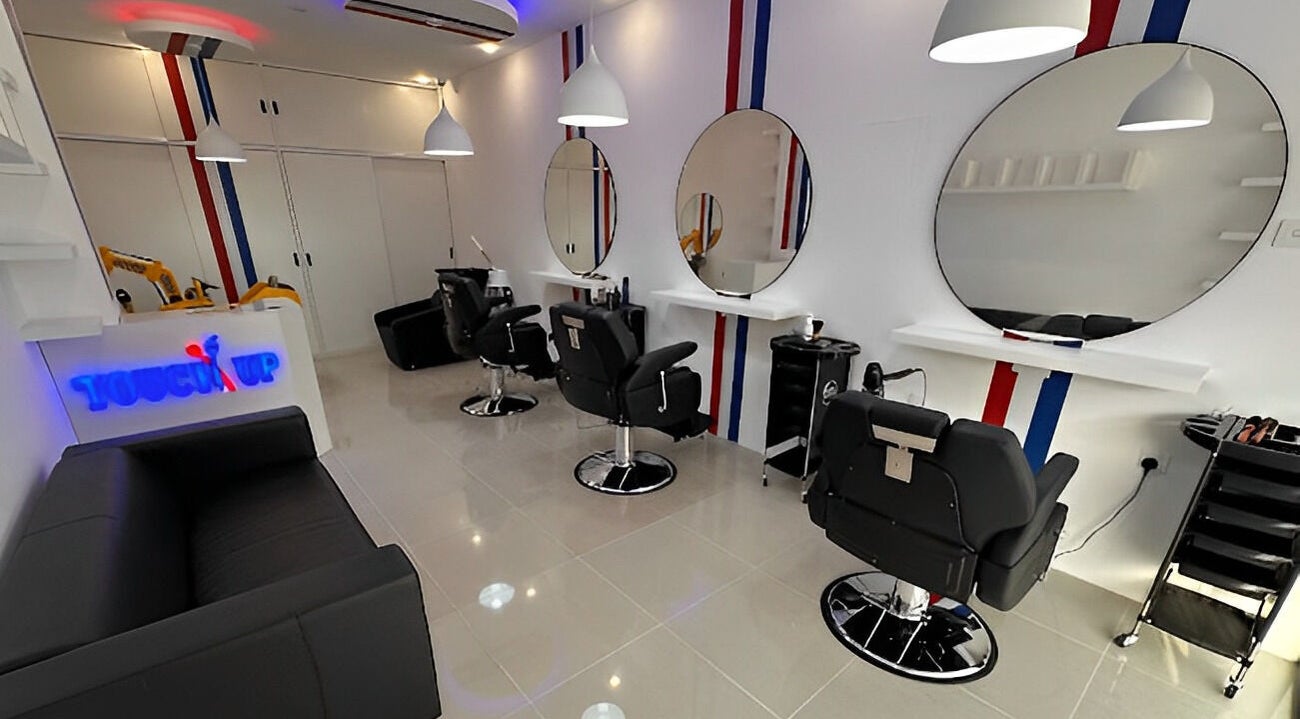 Modern salon interior at TOUCH UP - Wadi Kabir, Muscat, Oman. Sleek black chairs and mirrors, Wadi Al Kabir, Muscat Governorate.