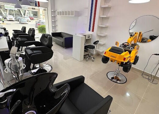 Interior of TOUCH UP - Wadi Kabir, Muscat, Oman featuring stylish salon chairs and bright decor.